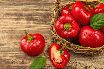 Ripe red round peppers in a handmade wicker basket