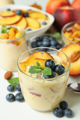 Concept of healthy food with peach yogurt and ingredients on white background