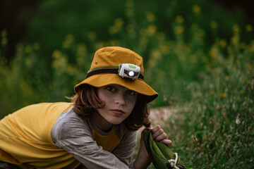 Young boy scout with head lamp on adventure in nature