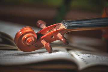 Fototapeta na wymiar Violin handle resting on a score