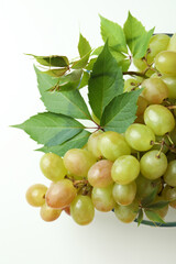 Bowl with green grape on white background, close up