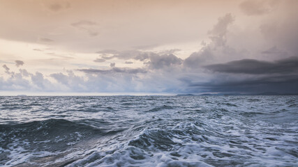Obraz premium Nature in twilight period which including of sunrise over the sea and the nice beach. Summer beach with blue water and purple sky at the sunset. 
