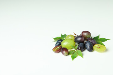 Ripe grape with leaves on white background