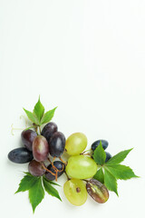 Ripe grape with leaves on white background