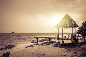 Nature in twilight period which including of sunrise over the sea and the nice beach. Summer beach with blue water and purple sky at the sunset.	
