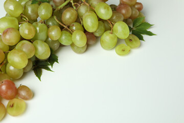 Green ripe grape with leaves on white background