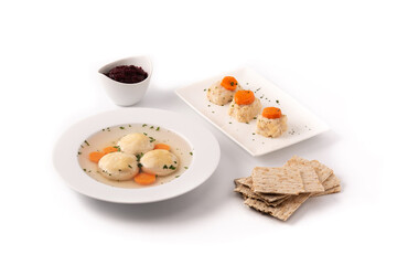 Traditional Jewish matzah ball soup, gefilte fish and matzah bread