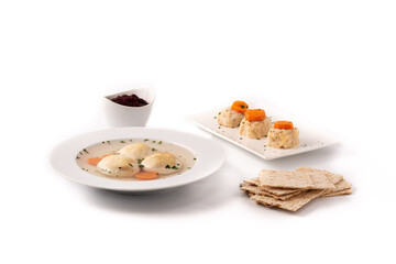 Fototapeta na wymiar Traditional Jewish matzah ball soup, gefilte fish and matzah bread
