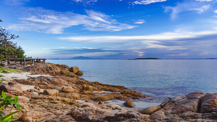 Nature in twilight period which including of sunrise over the sea and the nice beach. Summer beach with blue water and purple sky at the sunset.