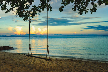 Nature in twilight period which including of sunrise over the sea and the nice beach. Summer beach with blue water and purple sky at the sunset.