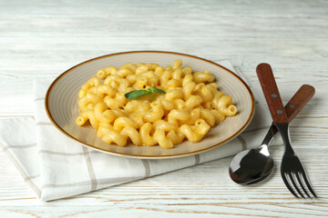 Concept of tasty eating with macaroni with cheese on wooden background