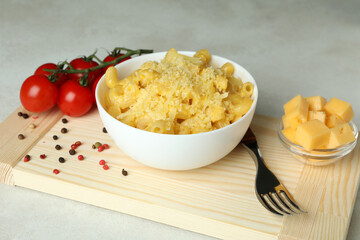 Concept of tasty eating with macaroni with cheese on white textured table
