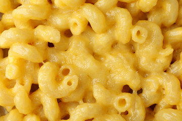 Macaroni with cheese all over background, close up