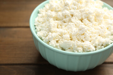 Delicious fresh cottage cheese on wooden table, closeup