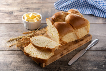 Braided egg bread on wooden table	