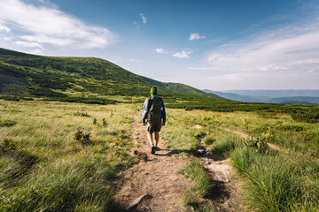 Obraz premium mountain tourism concept. hiking in the mountains. tourist with a backpack on his shoulders traveling. summer vacation