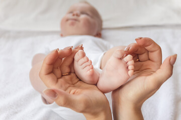 baby. love for babies. maternal hands holding baby's feet. upbringing and development of children