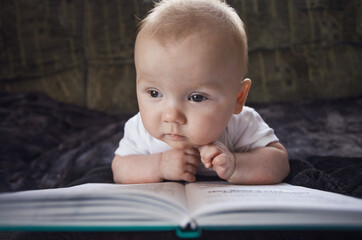 concept of education and development of children. babies are developed. baby reading a book....