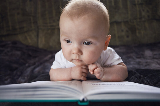 concept of education and development of children. babies are developed. baby reading a book. creative photography.
