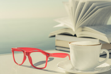 Coffee cup and books outdoors