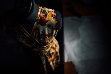 top view of a yellow-red dress made of natural fabric on a mannequin. close-up photo of clothes. smooth seams and stitches are stitched with thread. the seamstress makes individual tailoring at home.