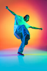 Conceptual portrait of young man, hip-hop dancer in stylish clothes in action isolated on colorful...