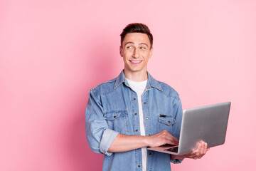 Photo of young positive cheerful dreamy businessman thinking brainstorming hold laptop isolated on pink color background