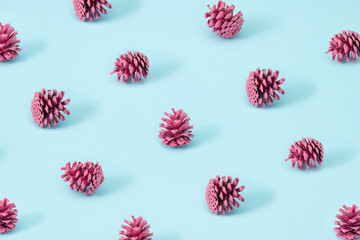 Vintage pattern creative concept of pastel pink pinecone on blue background. Autumn is coming.