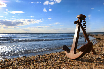 Wooden anchor near river on sunny day © New Africa