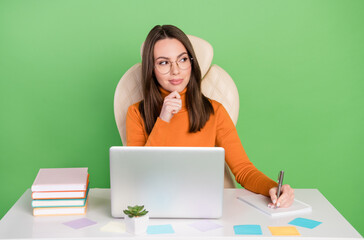 Portrait of attractive cheery trendy skilled minded girl creating strategy writing to-do list isolated over bright green color background