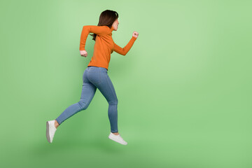 Fototapeta na wymiar Full length body size profile side view of nice sportive confident girl jumping running sprinter isolated over bright green color background
