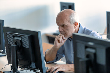 Hardworking businessman concentrating on his desktop computer
