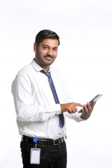Young indian man using smartphone on white background.