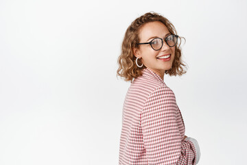 Corporate people. Enthusiastic businesswoman in glasses and suit, turn head at camera and smiling...