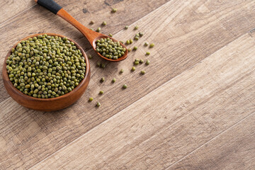 Close up of raw mung bean on wooden table background.