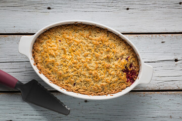Grated pie with plums is prepared in the home kitchen, top view