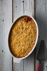 Grated pie with plums is prepared in the home kitchen, top view