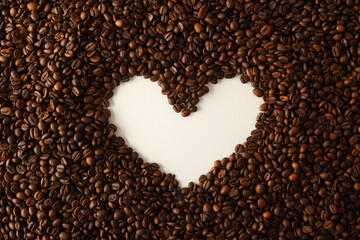 Coffee beans forming hollow of white heart top