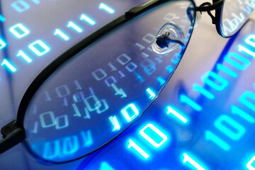Reflect picture digital text 0 and 1 on eyeglasses lenc which on tablet screen , technology concept.  