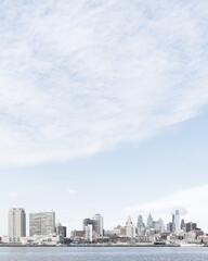 city skyline with large blue sky - space for copy and typography - soft cloud texture - buildings - river - waterway - winter season - wanderlust - city travel - world travel