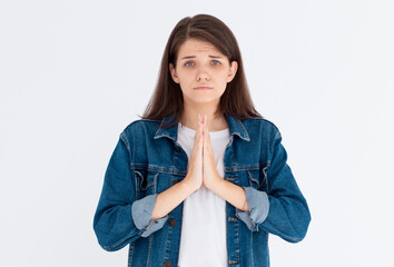 Worried woman need something, begging for help and say please. Girl apologizing, making clingy sad face and pleading you, standing against white background