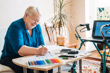 Hobby Ideas for Older People. Retirement Hobbies, Pastimes for Seniors. Activities for Seniors with Limited Mobility. Mature, elderly woman practices spelling words, online hand lettering class