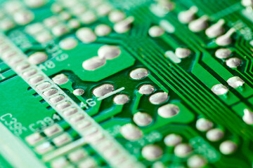 Electronic printed circuit board green with copper tracks, macro close-up, bokeh effect