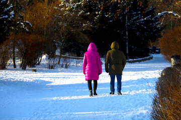 Seniors stroll through the park in winter.