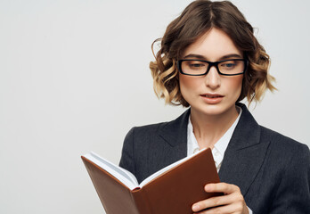 woman with glasses notebook in hand isolated background