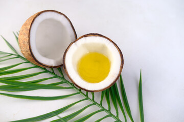 slice of fresh coconut and oil on white background 