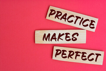 Practice Makes Perfect Text on Wooden Blocks on red Background
