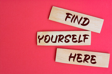 Find Yourself Here Text on Wooden Blocks on red Background