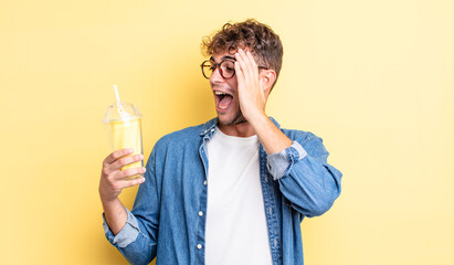 young handsome man feeling happy, excited and surprised. milkshake concept