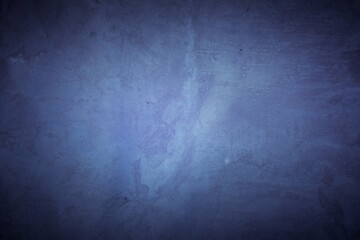 Old purple wall in spots, cracks, stains. Painted concrete wall in abstract grunge style loft. Vintage wall background texture for backgrounds, portraits, posters.